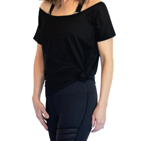Fit For Barre Off The Shoulder Tunic designed in a cotton black fabric that can be worn long or tied up for a more fitted look.