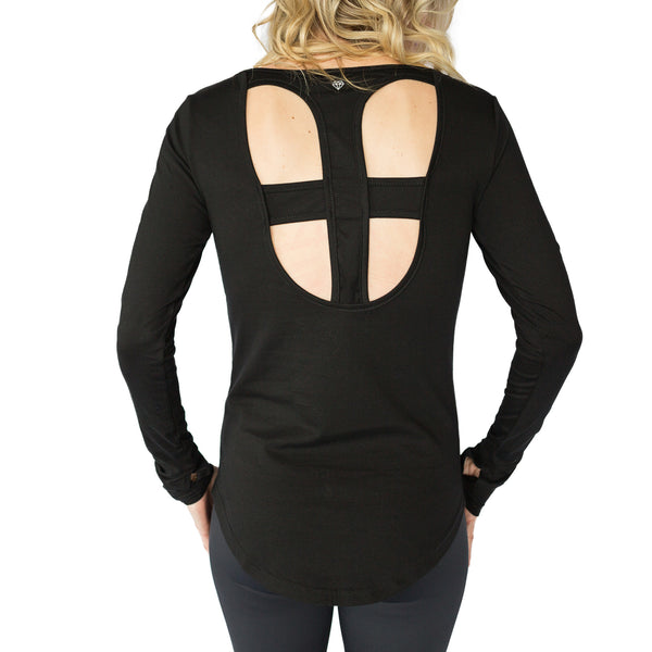 Fit For Barre Open Cross Back Top in a bamboo blend black fabric, with thumbhole sleeves and a longer, rounded hem in the back.